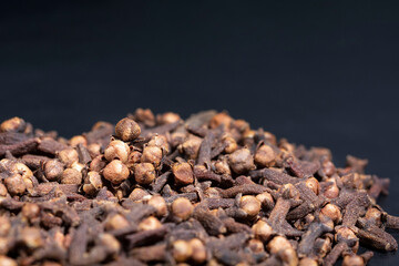 clove grains on a black color background