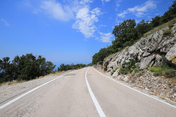 Fototapeta na wymiar Empty downhill highway in the mountains