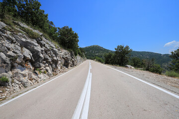 Empty uphill highway in the mountains