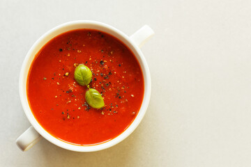 Italian tomato soup with basil and spices.Close up, top view, copy space