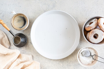 Recipe for delicious homemade donuts with sugar on a white stone background. Top view.