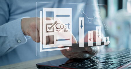 Cost reduction Concept. Businessman with his hand lowers the arrow of the graph. Cost text with a...
