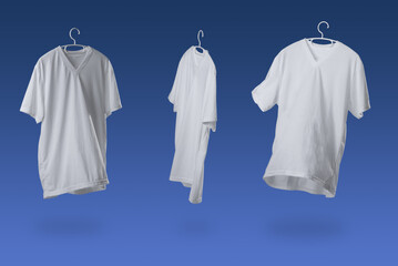 White tshirt with hanger. Flying cotton T-shirt against a blue background
