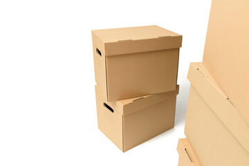 Closed stacked cardboard boxes on a white isolated background with space for text. The concept of a delivery or relocation service.
