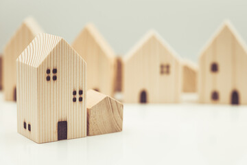 small wooden home model represent good community living together social concept.