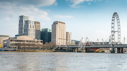 The South Bank, London. A view south over the River Thames towards Hungerford Bridge and the Royal Festival Hall arts venue and London Eye landmarks. - obrazy, fototapety, plakaty