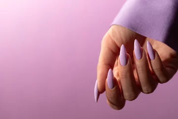 Badezimmer Foto Rückwand Female hand with a beautiful purple long nails manicure on a lilac background © nika57