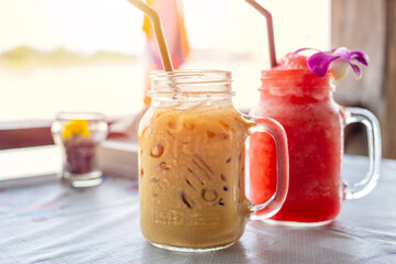 Iced coffee with water melon ice frappe on wooden table for fresh cold summer drinks.