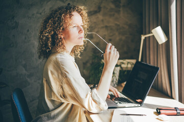 Woman working at co-working using laptop, female working in modern studio. Networking, Freelancer Entrepreneur.