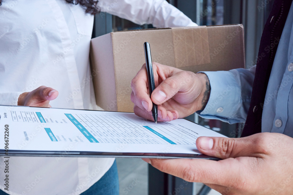 Poster Just checking to make sure all is in order. Closeup shot of an unrecognisable delivery man filling in paperwork while making a delivery to a customer.