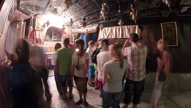 Church of the Nativity interior with altar and icon lamps hanging on long chain in Bethlehem timelapse.