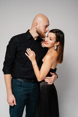 A lovely couple is hugging. Bald hipster man hugging a beautiful woman.