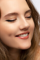 Obraz premium Close-up of woman's lips with fashion natural beige lipstick makeup. Macro sexy pale lipgloss make-up . Gentle pure skin and wavy blonde hair. Cosmetology, Spa, increase in lips