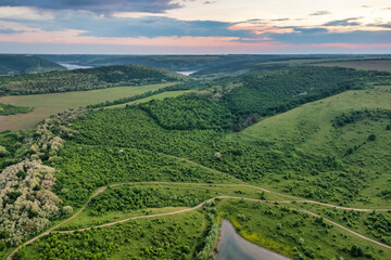 Fototapeta na wymiar Magnificent aerial view of the Dniester River with picturesque banks. Bakota National Natural Park, Podolskie Tovtry, Ukraine. Beautiful view from a flying drone.