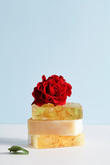 Set of beautiful handmade natural soap with red rose on white and blue background. organic simple, eco friendly, spa skincare concept. copy space. 