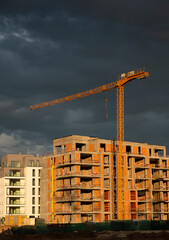 Sunset on a construction site for a new premium residential flat building. Construction industry.