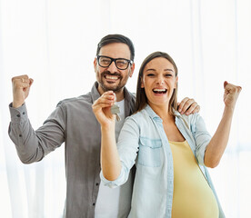 couple key house happy young home celebrating celebration achievement new investment pregnant mother pregnancy real estate apartment holding buying love belly