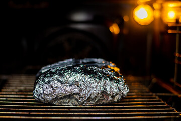 Meat in foil in the oven. Cooking, roasting pork.