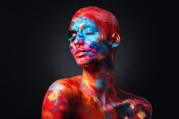 I feel complete in my art world. Shot of an attractive young woman posing alone in the studio with paint on her face and body. - obrazy, fototapety, plakaty