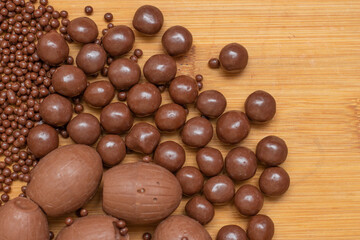 different types of chocolate balls  on a wooden table
