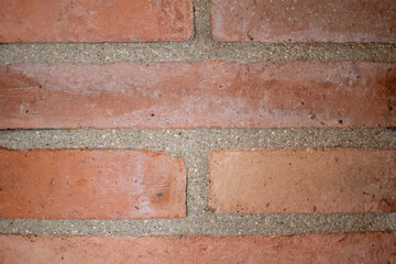 Obraz premium Red brick wall with grey cement texture. Industrial background.