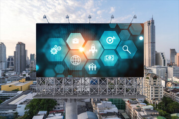 Hologram of Research and Development glowing icons on billboard. Sunset panoramic city view of Bangkok. Concept of innovative technologies to create new services and products in Southeast Asia.