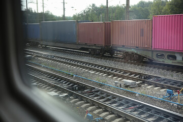 view from the train window to the railway station, freight train and railway