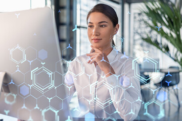 Attractive businesswoman in white shirt at workplace working with laptop to optimize development by...