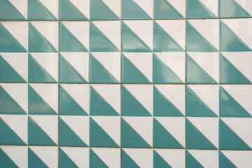 Triangle white-green tiles on the wall