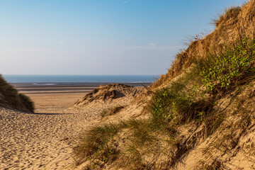Looking out between sand dunes towards the ocean, at Formby in Merseyside