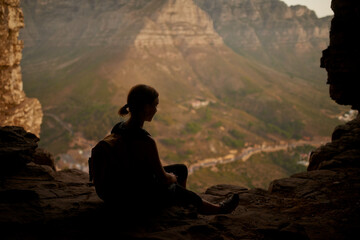 Taking the rugged route to paradise. Shot of a woman admiring the view from a mountain top.