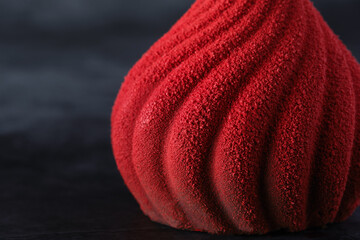 Delicious red dessert closeup on black background