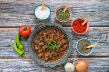 Asian cuisine, fine dining - close-up, braised soft lamb liver in tinned copper dish .