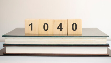 1040 tax Word Written on Wooden Cubes on yellow and gray background