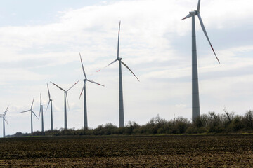 The wind farm consists of several picturesque wind turbines. Green energy in action. Renewable energy.