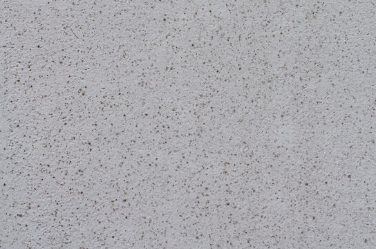 White Wall Decorated Plaster With Black And Grey Dots