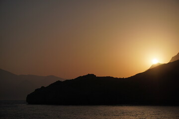 Fototapeta na wymiar Mountains over the sea during sunset