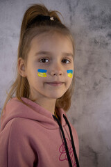A child with the flag of Ukraine is crying. Sadness longing hope. Tear macro. Children's tears from...