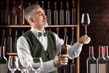 Sommelier with a glass of wine. Examination of wine products. Restaurant staff, expert wine steward...