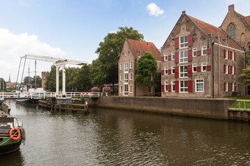 Fototapeta na wymiar Old canal houses and pedestrian drawbridge over the Thorbeckegracht in the center of Zwolle.