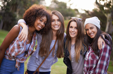 Best friends hanging out in the park. Cropped shot of a group of young women enjoying the outdoors...