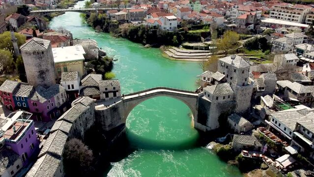 Old Bridge and Neretva river in Mostar, Bosnia and Herzegovina. Aerial drone view of Old town Mostar in spring.