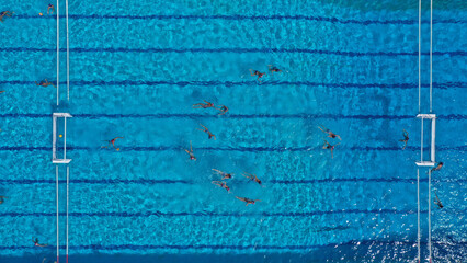 Aerial drone top down photo of water polo tournament as seen in huge pool