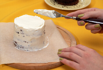 Leveling the white cream on the bento cake with palette knife. Picture for websites about desserts, food, confectionery. Selective focus.