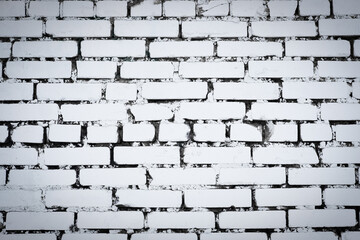 White brick wall texture background. Toned, vignetted backdrop. Damaged factory house wall. Old, dirty, painted, weathered and cracked bricks with concrete and stucco. Vertical, close up, copy space