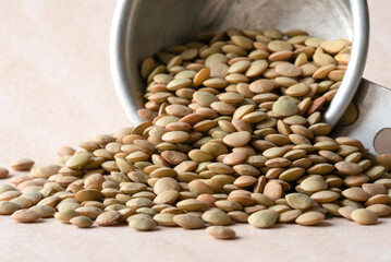 Uncooked Lentils Spilled from a Measuring Cup