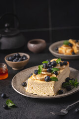 Homemade cottage cheese bake cake casserole with berries and banana on black background