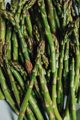 green asparagus stalks ready to be roasted in white dish