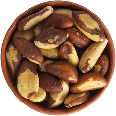 Brazil nut in a brown ceramic bowl. Isolated close-up photo of food close up from above on white background.