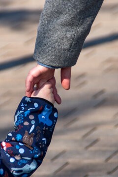 Toddler holding mothers hand